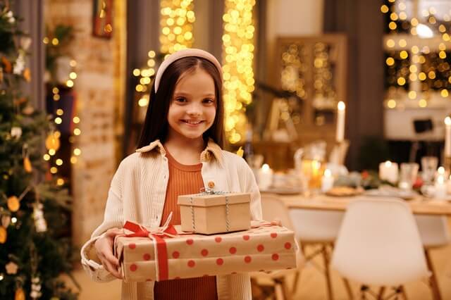 A young girl holds a Christmas present that was donated to her in Chicago